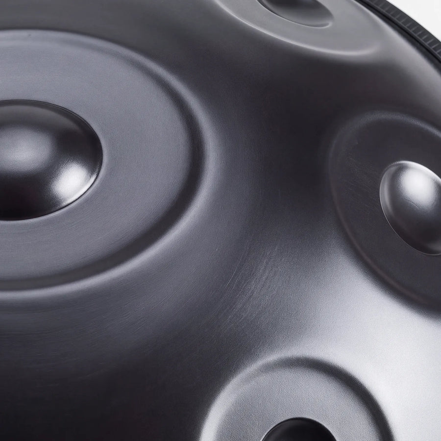 Close view of the central ding on a Sonant D Kurd handpan with 10 notes in a black finish — 11