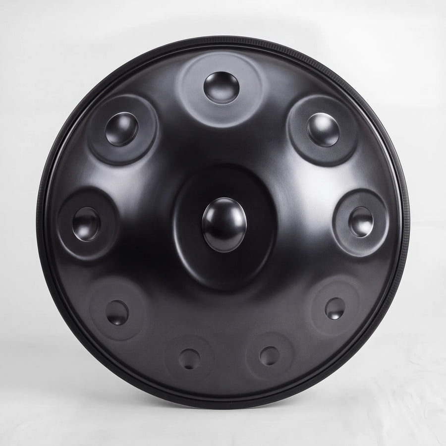 Front view of a Sonant D Kurd handpan with 10 notes in a black finish, showing its central dome and 9 tone fields — 7