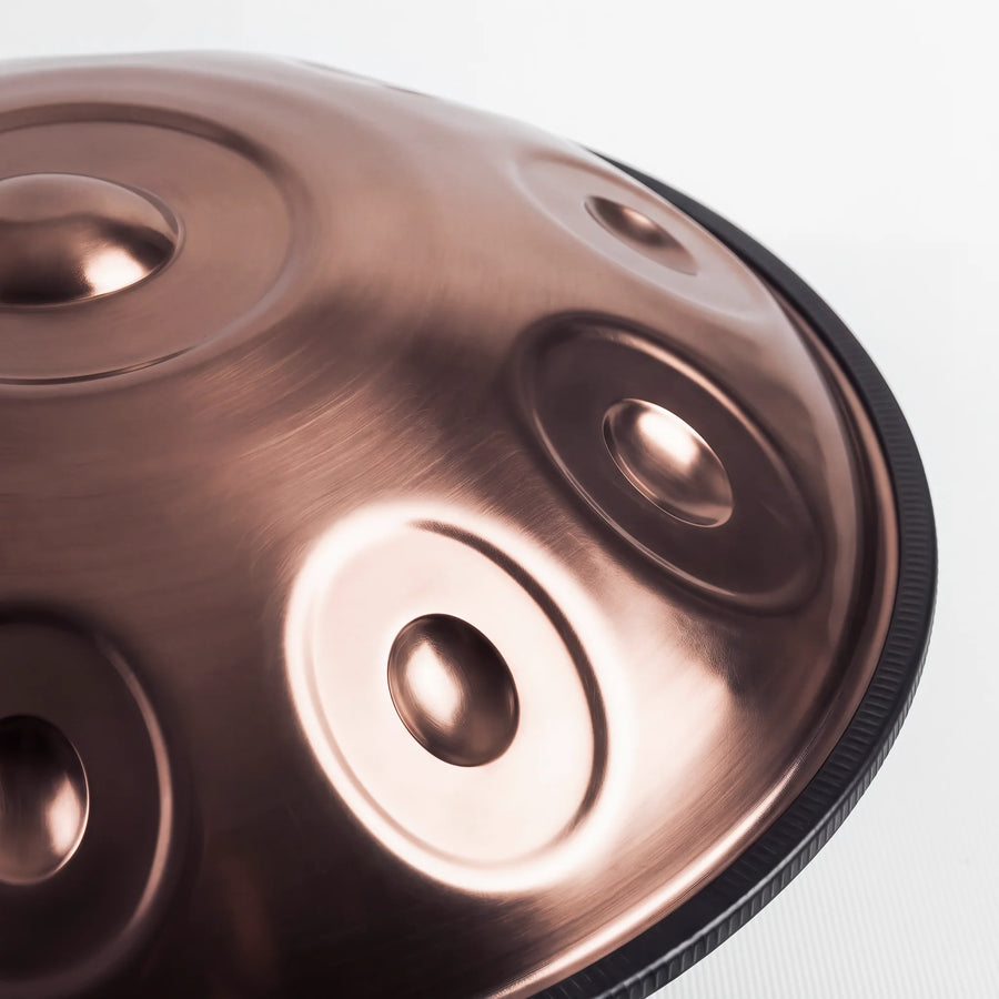Close view of a Sonant D Kurd handpan with 10 notes in a bronze finish, showing its tone fields and rim — 15