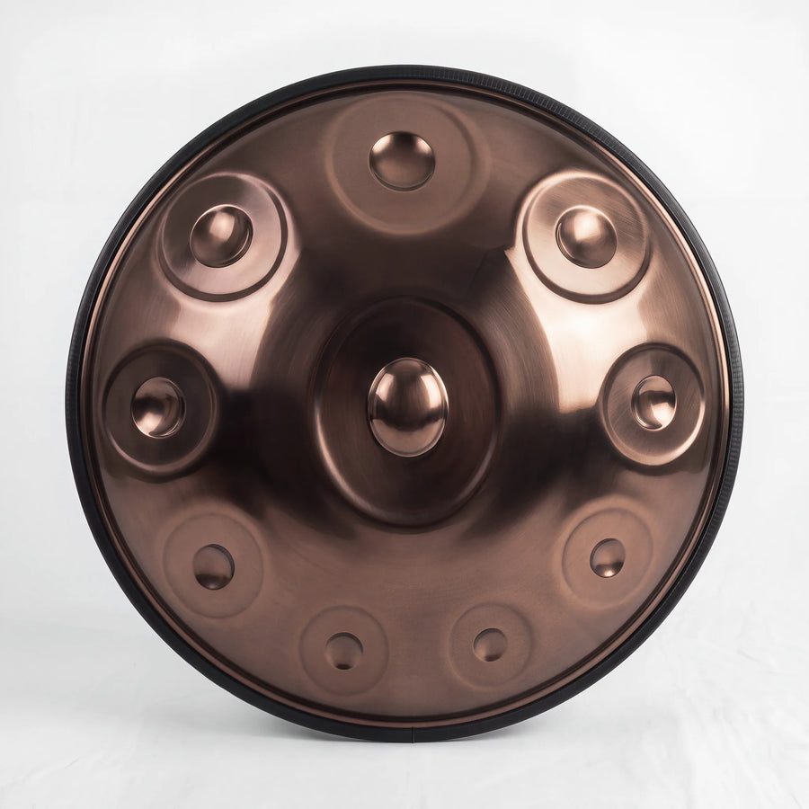 Front view of a Sonant D Kurd handpan with 10 notes in a bronze finish, showing its central dome and 9 tone fields — 13