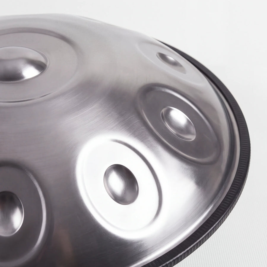 Close view of a Sonant D Kurd handpan with 10 notes in a silver finish, showing its tone fields and rim — 3