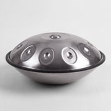 Sonant D Kurd handpan with 10 notes in a silver finish, viewed from the side with its rim and rounded bottom shell — 2