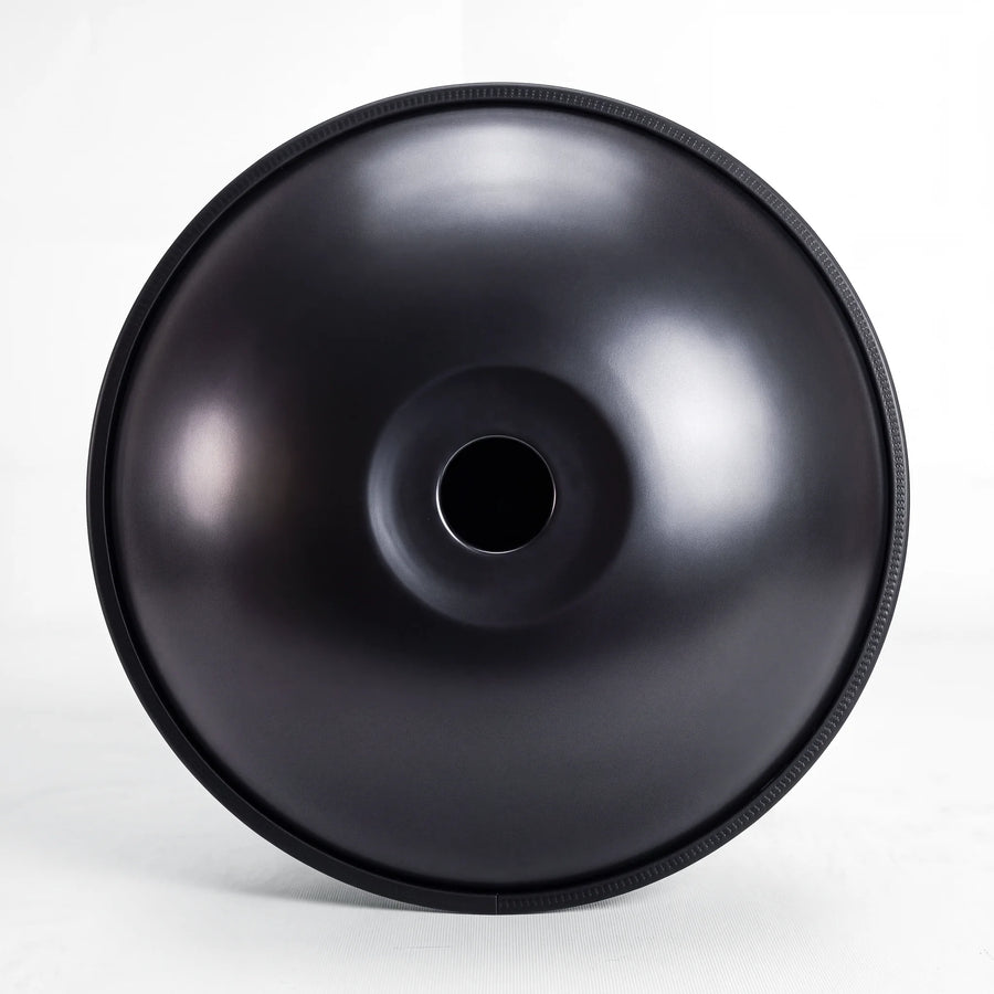 Underside of a Sonant D Kurd handpan with 12 notes in a black finish, showing its central opening and rim — 16
