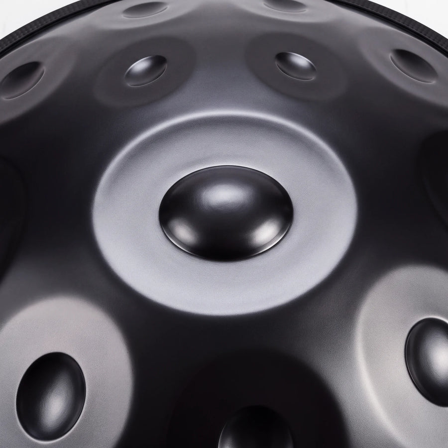 Close view of the central ding on a Sonant D Kurd handpan with 12 notes in a black finish — 17