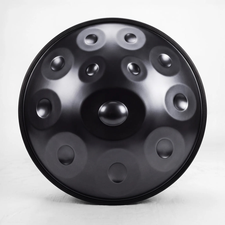 Front view of a Sonant D Kurd handpan with 12 notes in a black finish, showing its central dome and 11 tone fields — 13