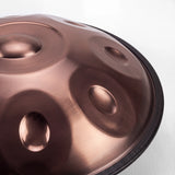 Close view of a Sonant D Kurd handpan with 12 notes in a bronze finish, showing its tone fields and rim — 3