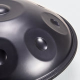 Close view of a Sonant D Kurd handpan with 9 notes in a black finish, showing its tone fields and rim — 3