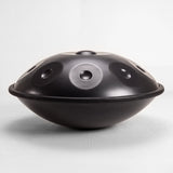 Sonant D Kurd handpan with 9 notes in a black finish, viewed from the side with its rim and rounded bottom shell — 2
