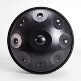 Front view of a Sonant D Kurd handpan with 9 notes in a black finish, showing its central dome and 8 tone fields — 1