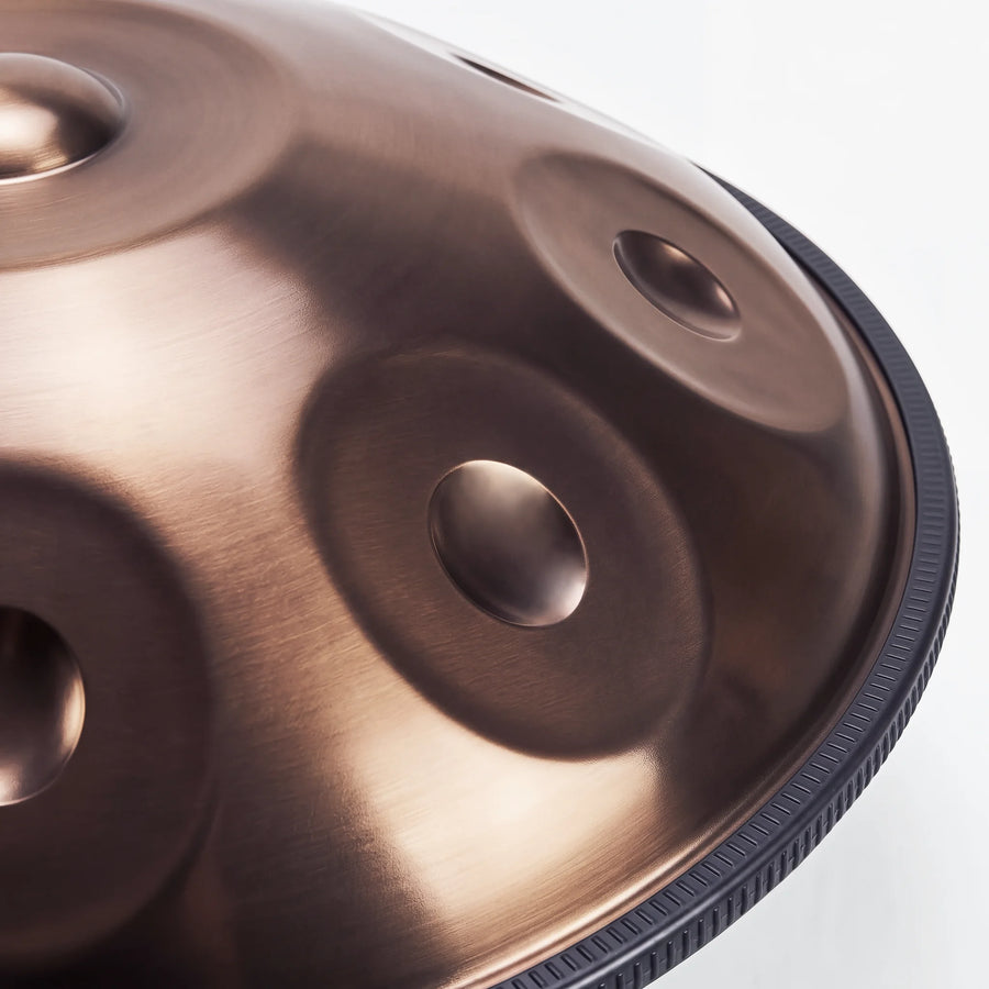 Close view of a Sonant D Kurd handpan with 9 notes in a bronze finish, showing its tone fields and rim — 15