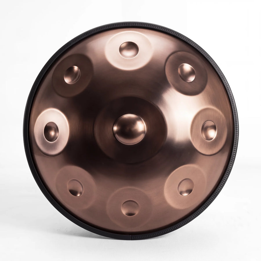 Front view of a Sonant D Kurd handpan with 9 notes in a bronze finish, showing its central dome and 8 tone fields — 13