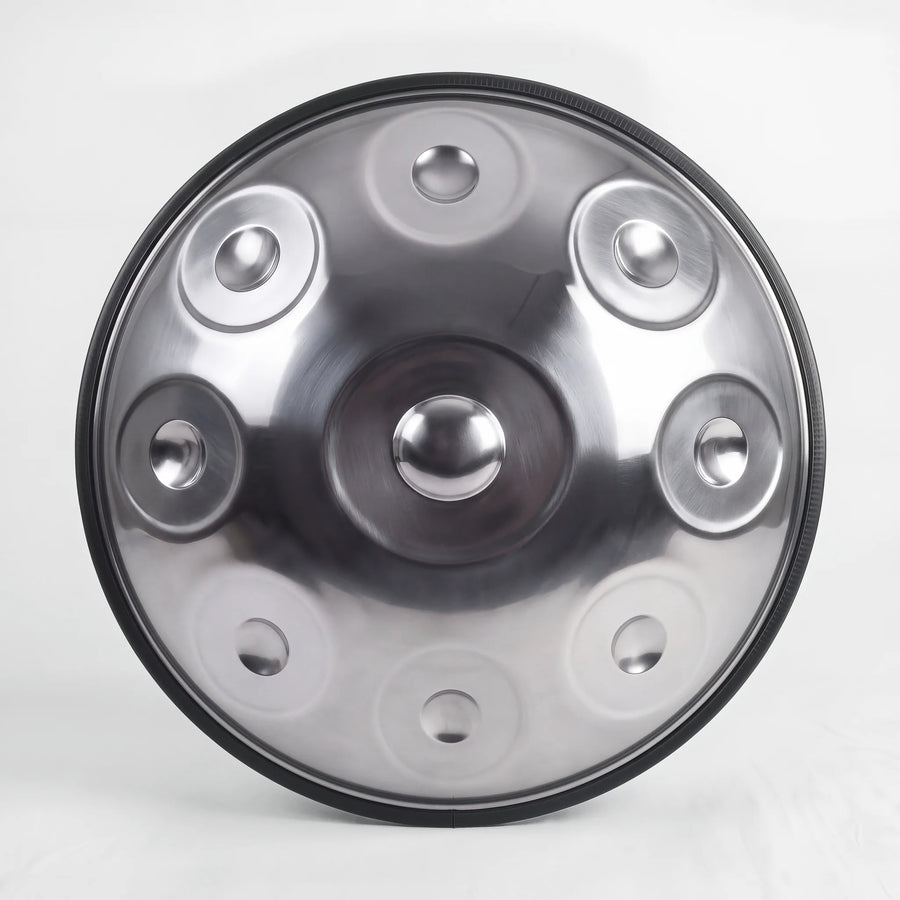 Front view of a Sonant D Kurd handpan with 9 notes in a silver finish, showing its central dome and 8 tone fields — 7